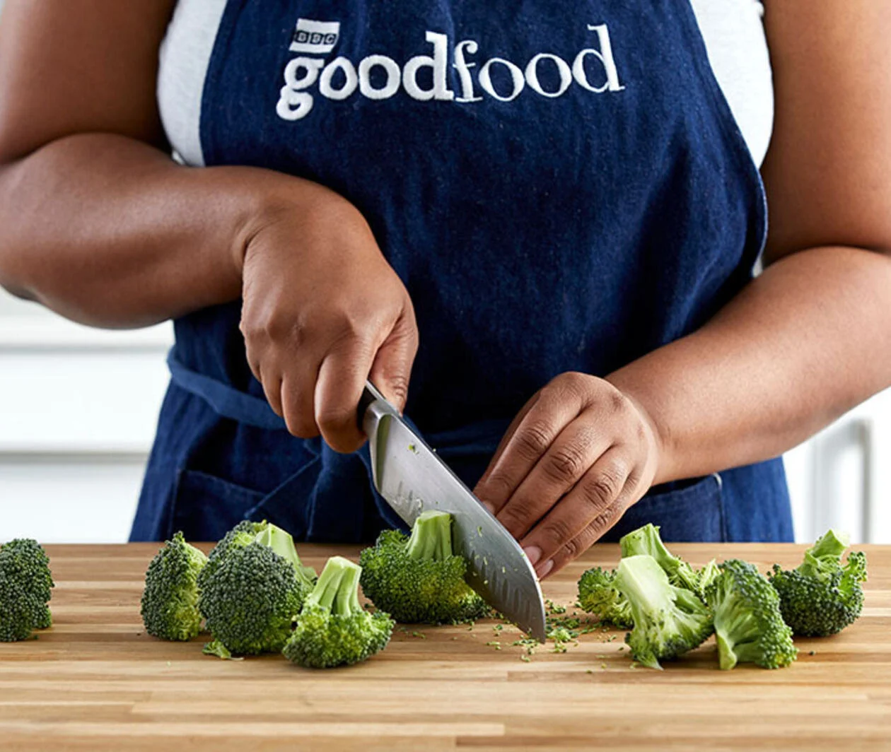 Person chopping broccoli