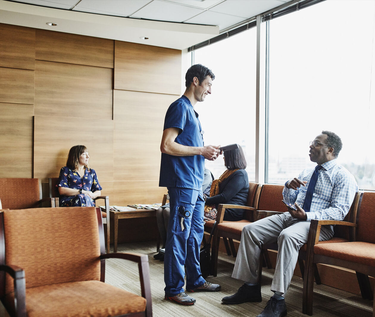 Health professional talking to autistic patient in waiting room 