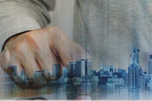 Man looks at a tiny virtual city