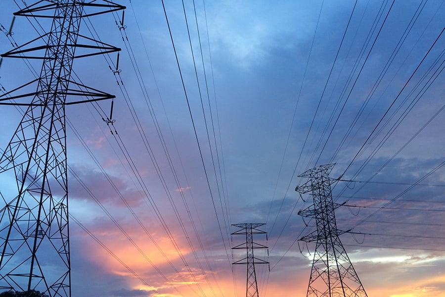 Power lines against sunset