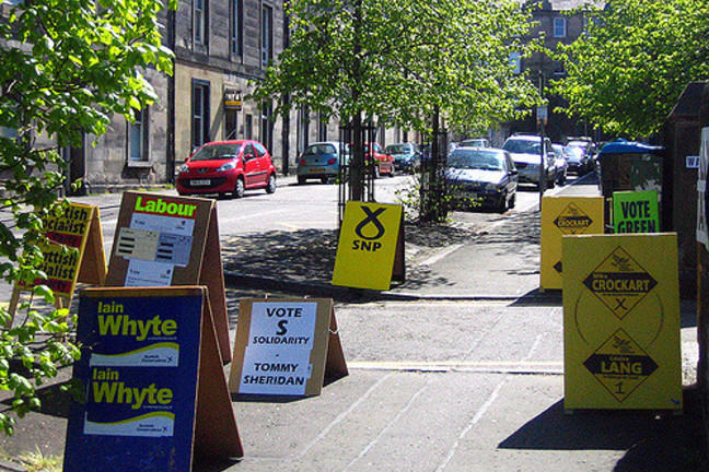 Campaign Signs on Stand-Up Billboards Lining Both Sides of a Sidewalk in a Street