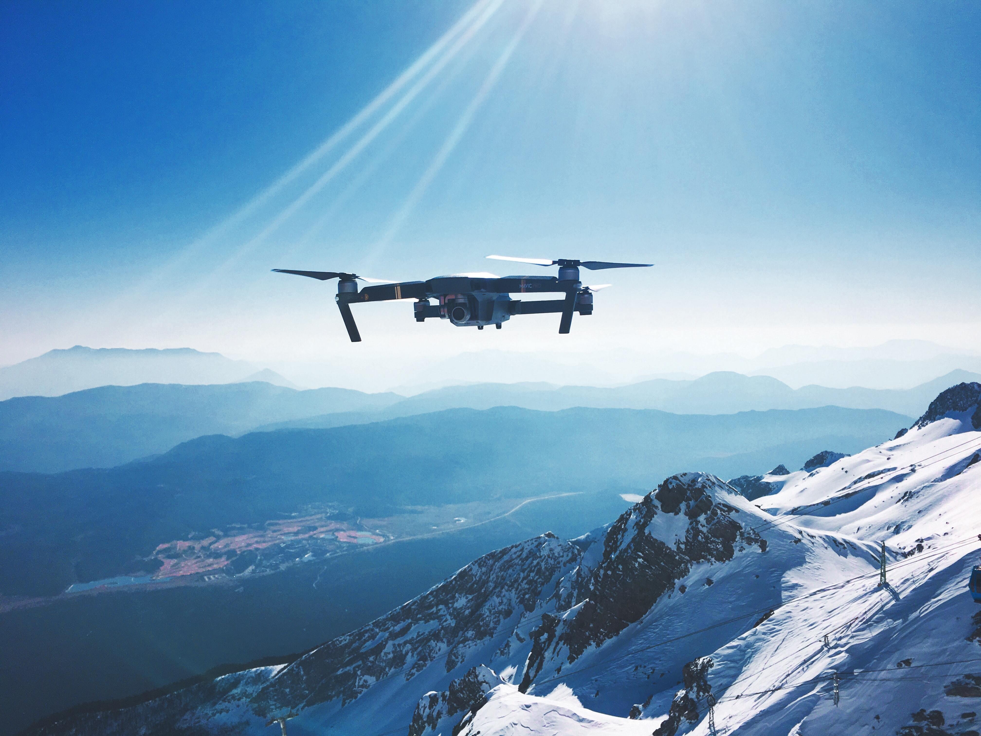 An image of a drone flying about a mountainous landscape.