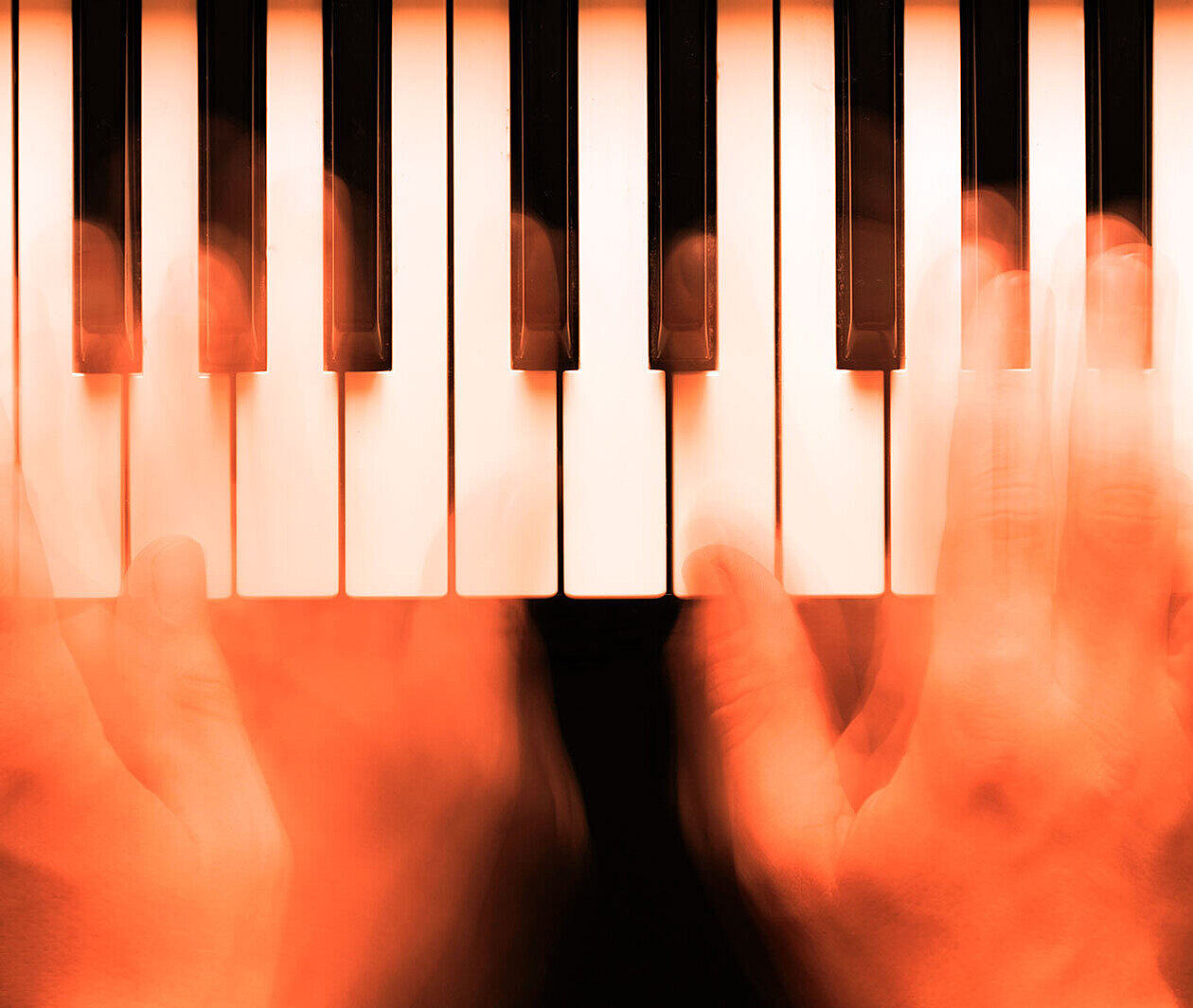 A pair of hands on a keyboard, playing jazz piano