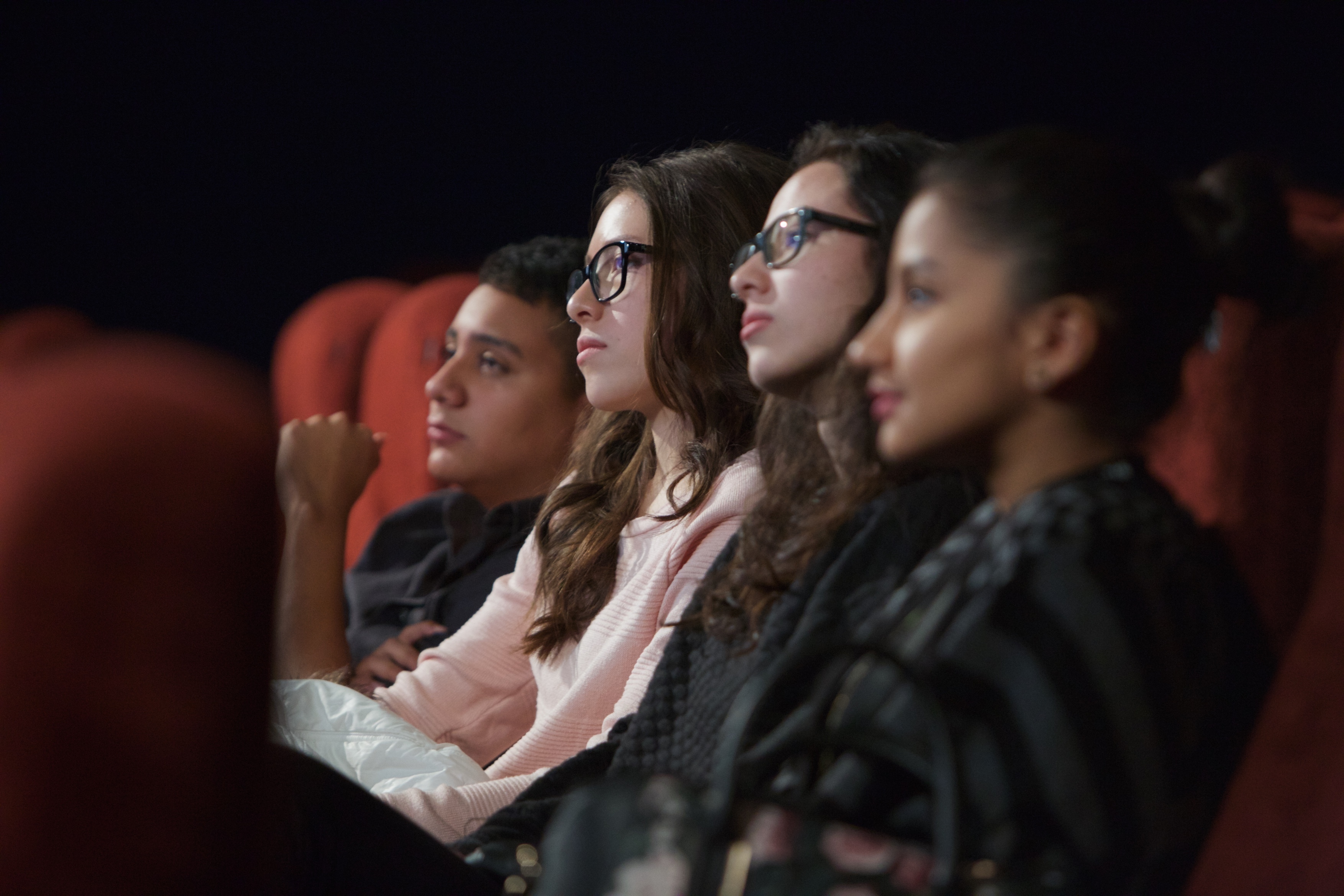 Group of students at the cinema watching a film