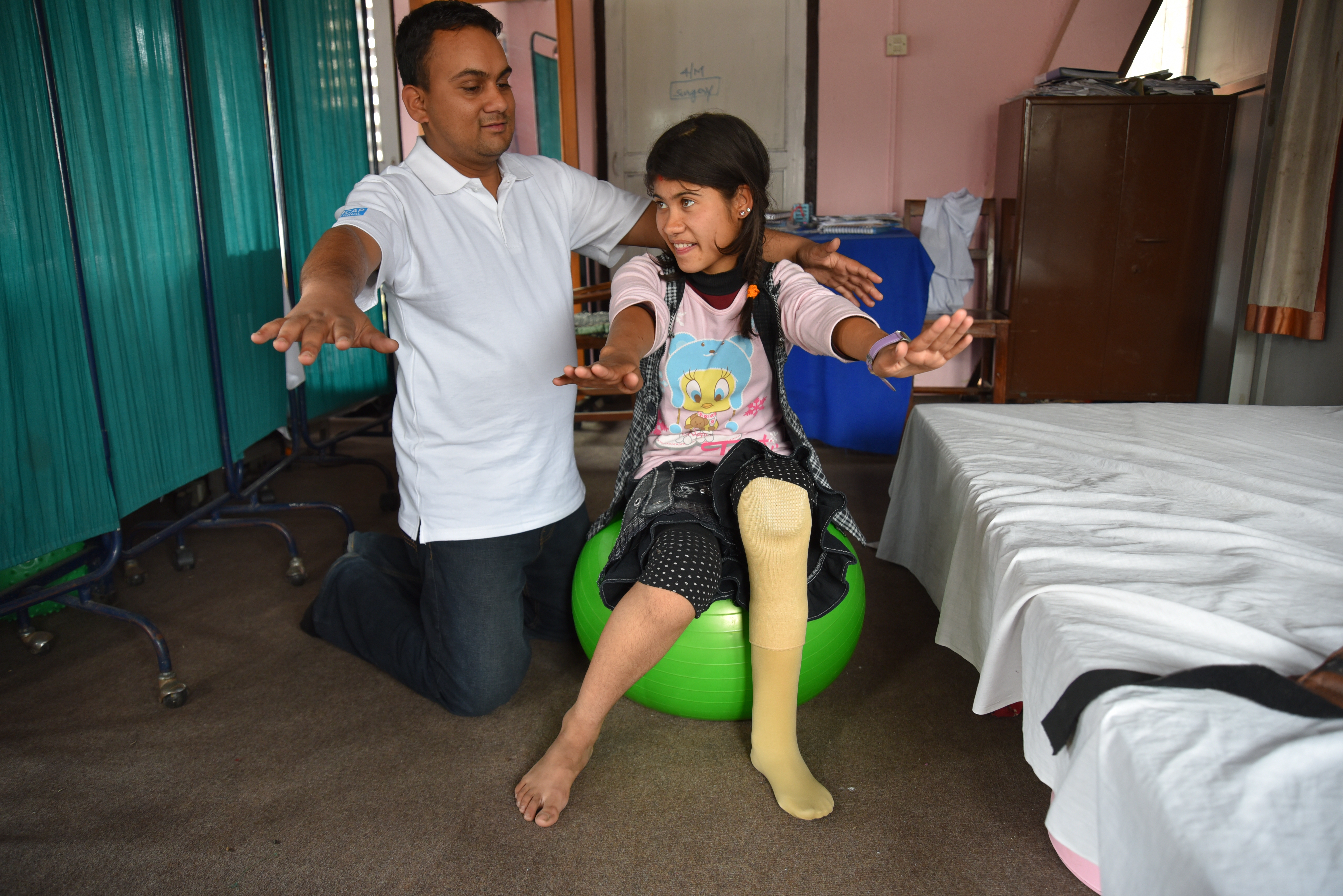 A rehabilitation session with Reema Puri (13) and Ashok Paudel, a physiotherapist at National Disabled Fund Rehabilitation Centre, Nepal