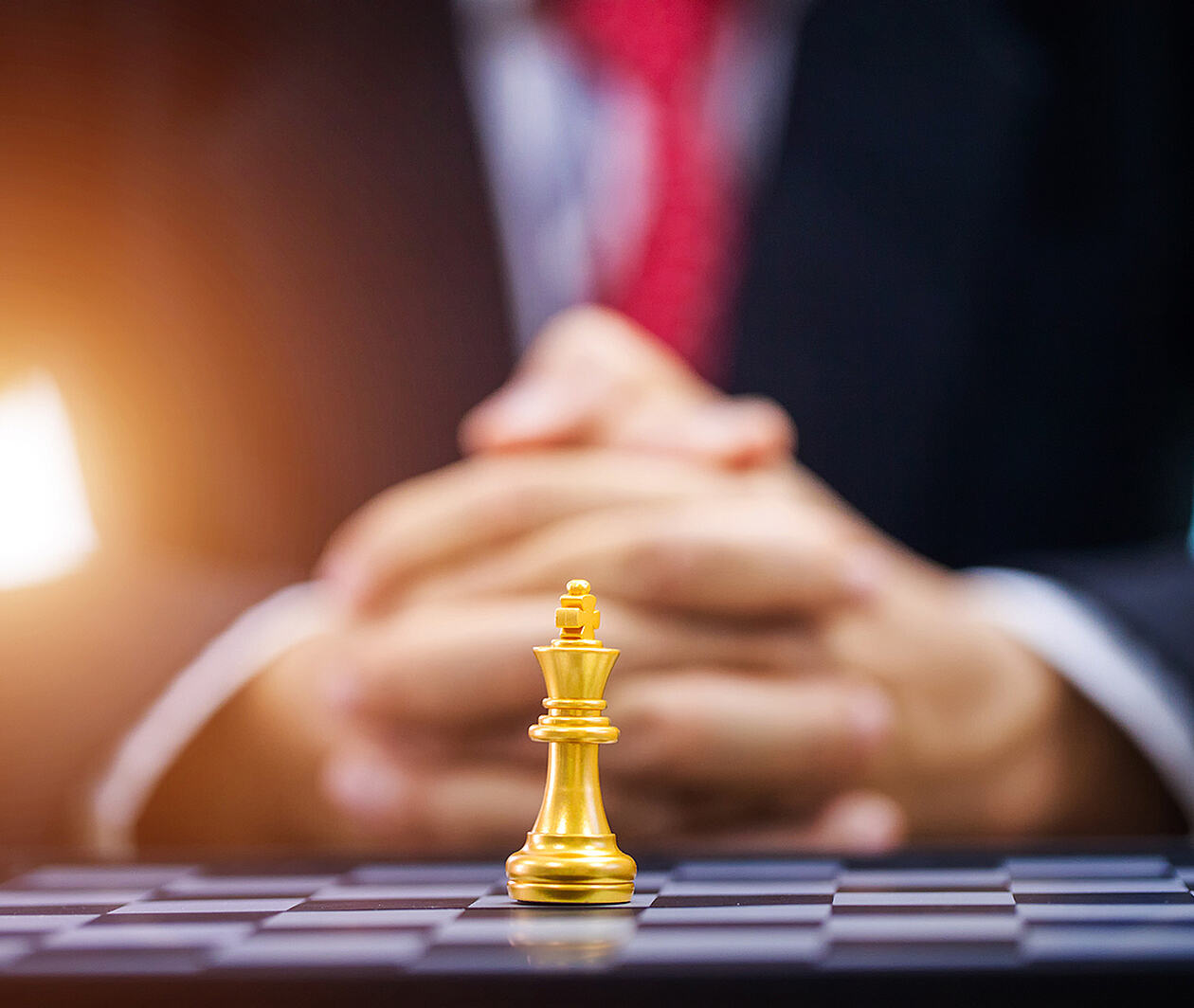 Businessman hand with businessman goal with chess.