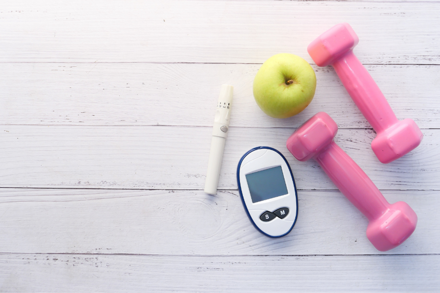 blood glucose test with apple and light weights