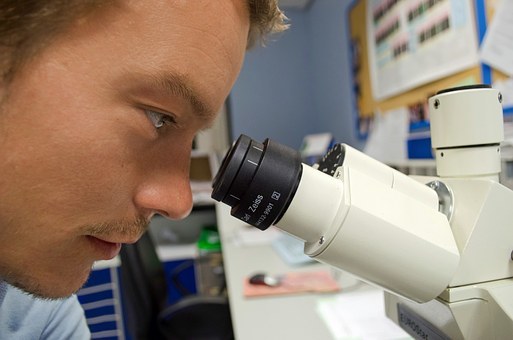 Scientist looking through a microscope