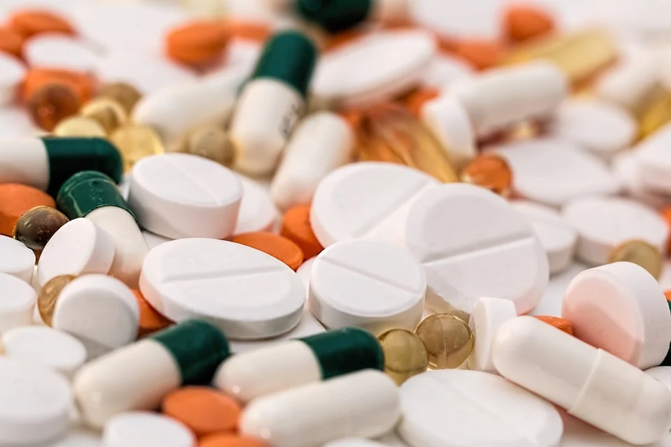 A pile of medicines - variously coloured pills and capsules.