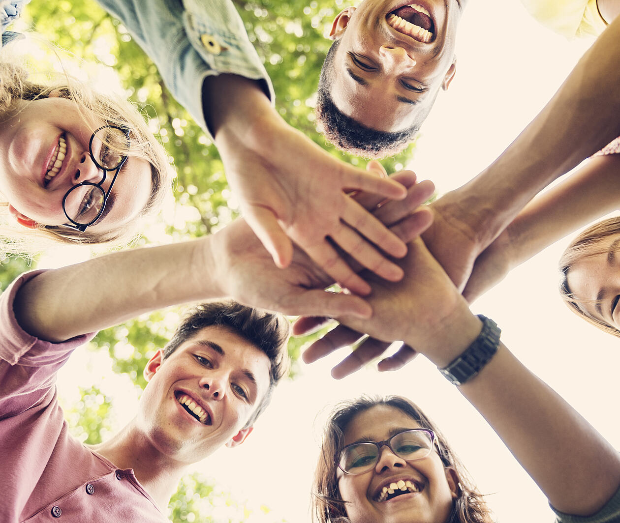 Group of adolescents with their hands together