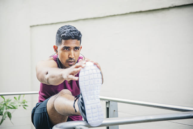 Man stretching in fitness clothing.