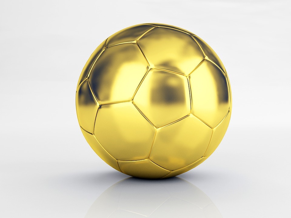 A gold coloured 32-panel football.