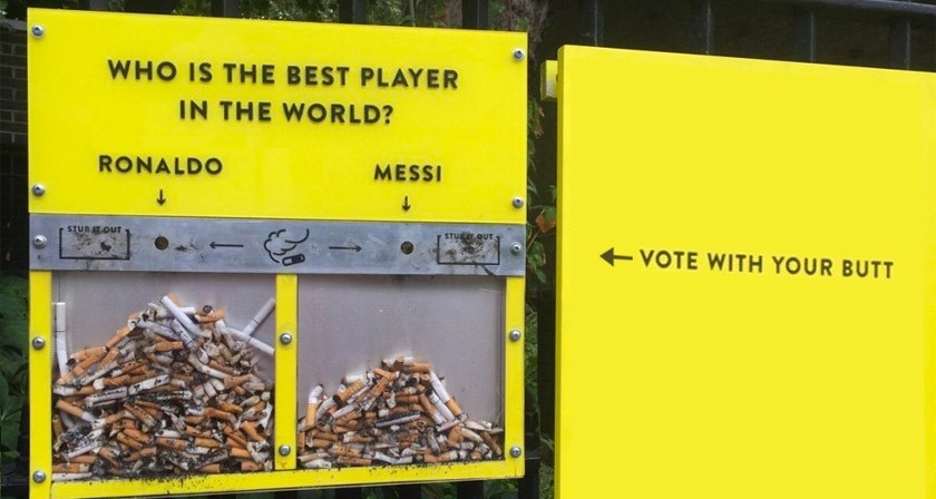 On a bright yellow background we see two clear containers containing cigarette butts, one labelled Ronaldo, the other Messi, with an overall title of ‘Who is the best player in the world’ and an instruction to ‘Vote with your butt’.