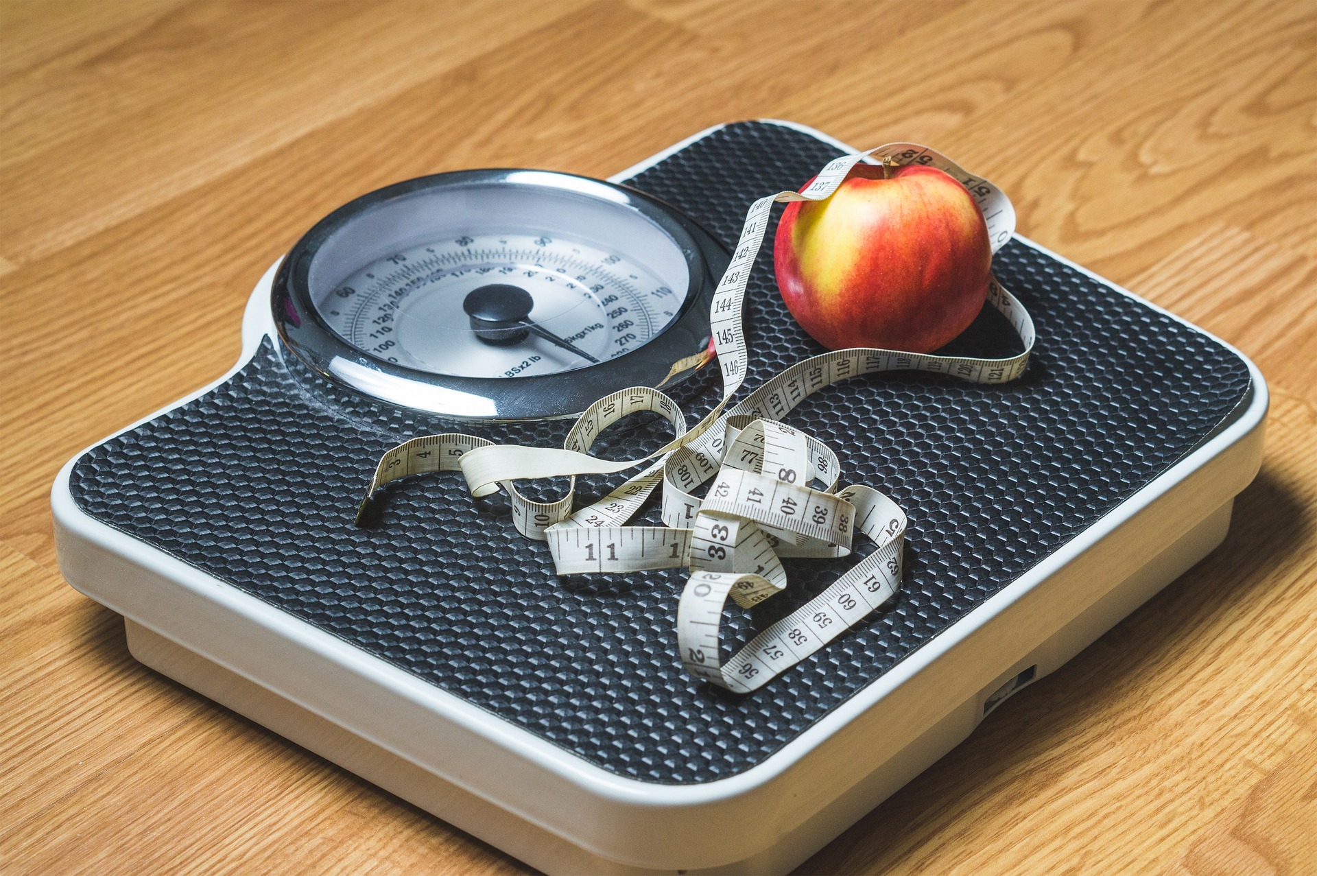 Scale, tape measure and an apple