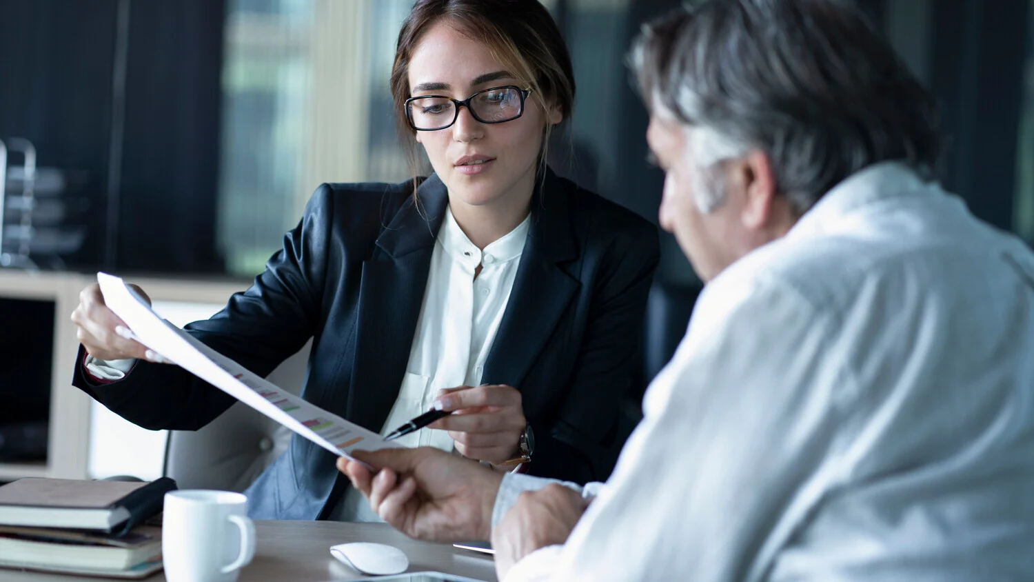 Image of a laywer showing paperwork to a client