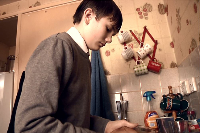 Boy washing up dishes