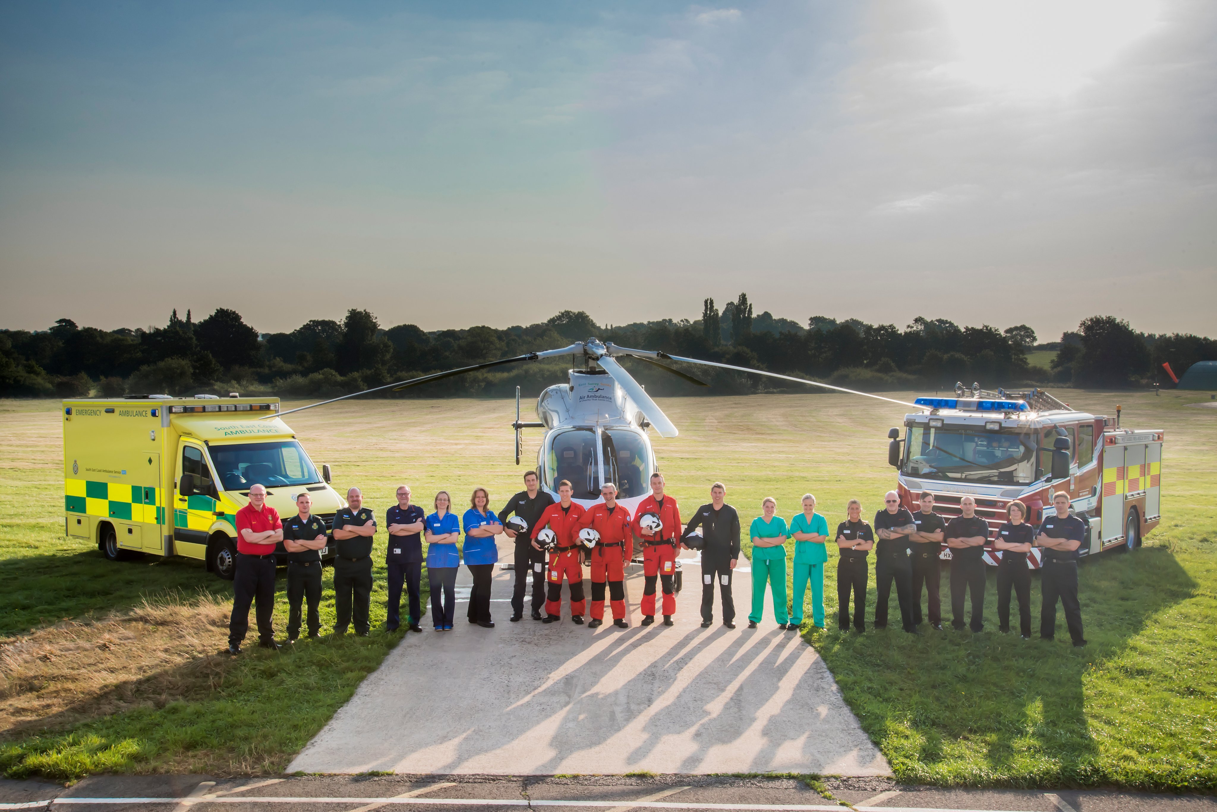 Image of emergency services MDT and ambulance, helicopter & fire engine in background