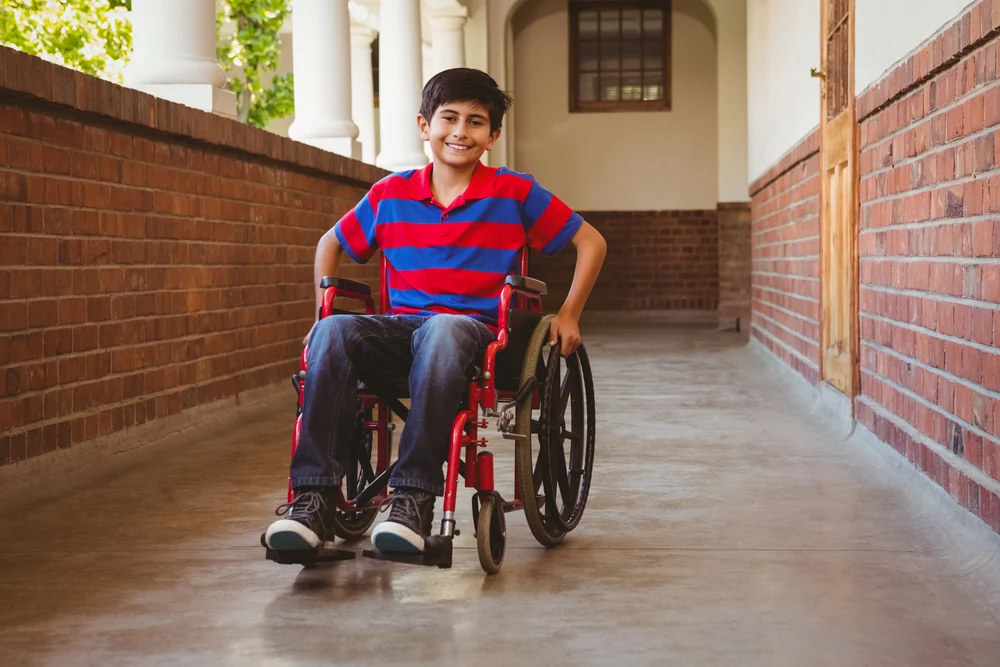 Boy sitting in wheelchair, smiling