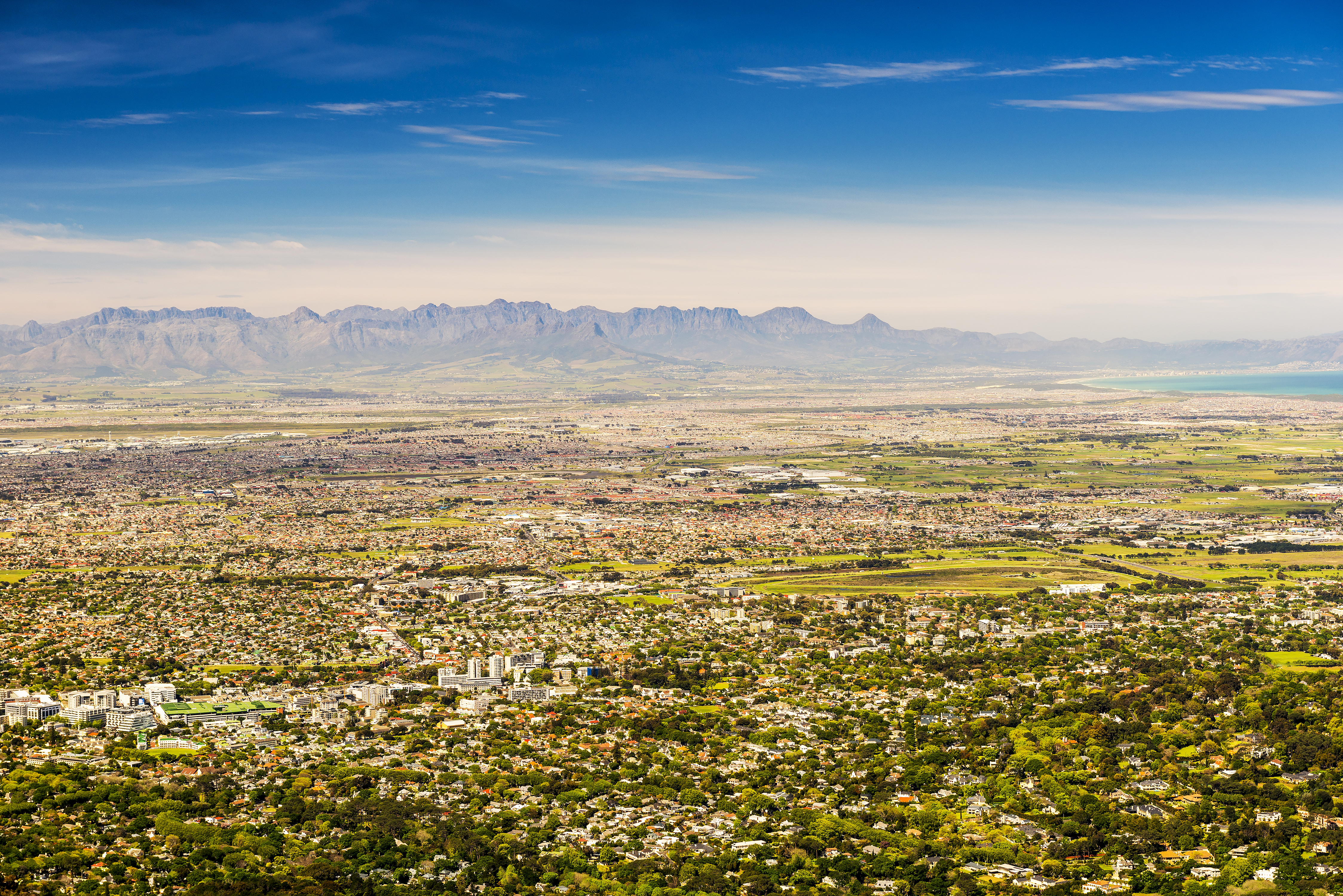 Aerial panorama of Cape Town with urban centres against the backdrop of the Table Mountain range