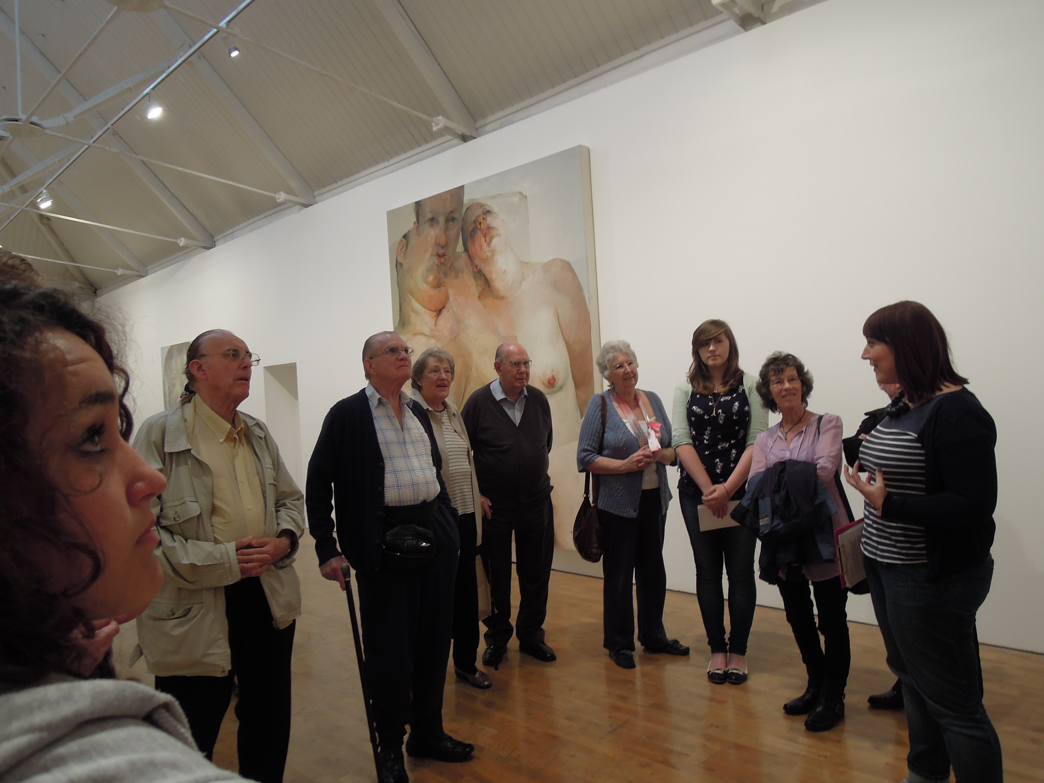 Photograph of a group of people visiting an art exhibition