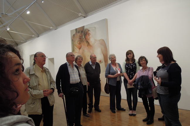 Photograph of a group of people visiting an art exhibition