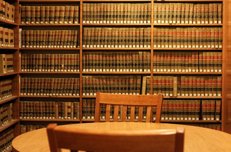 Table with two chairs in front of bookcase