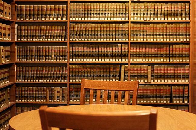 Table with two chairs in front of bookcase