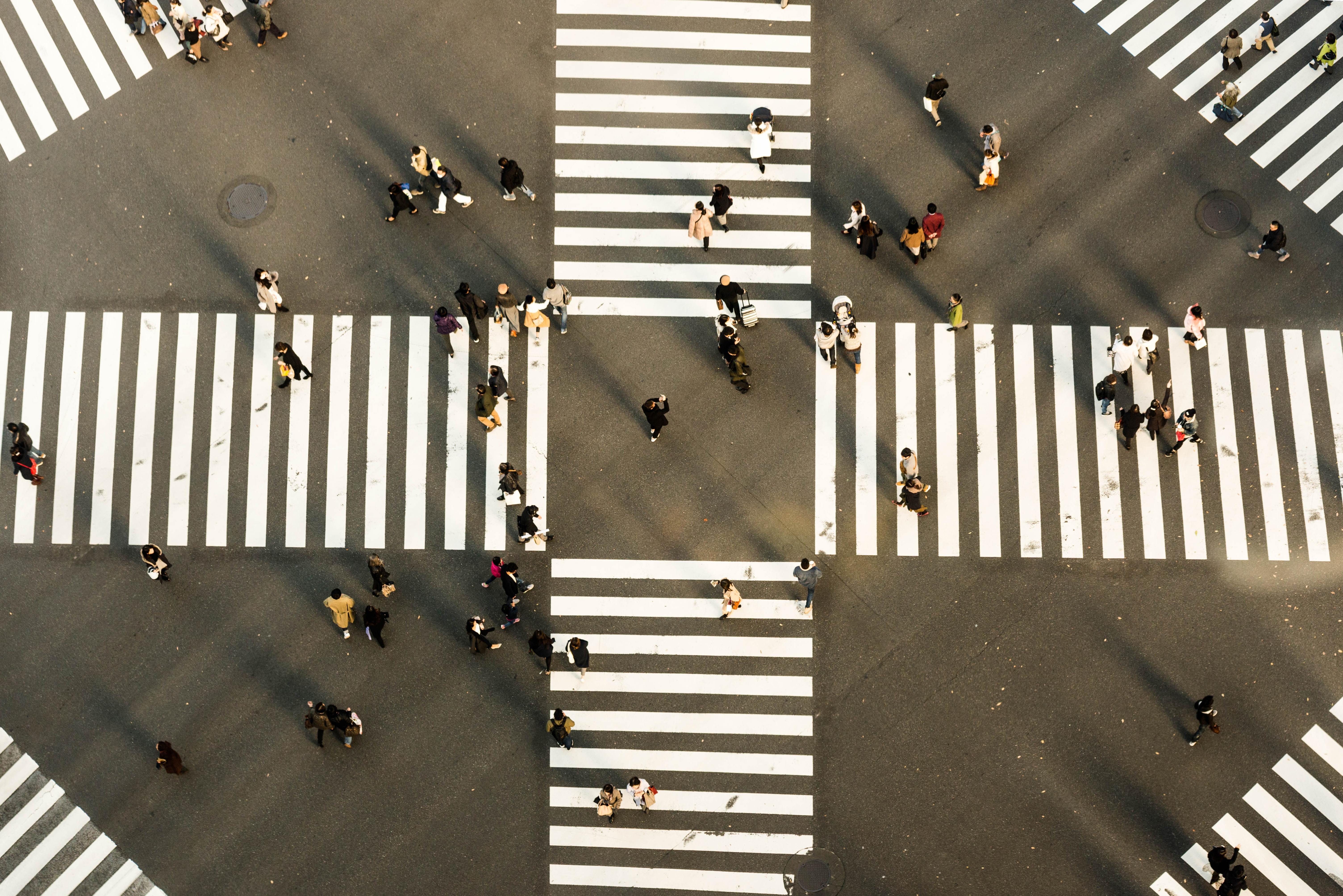 People walking on four zebra crossings