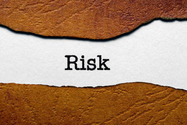The word "risk" printed in black on white paper