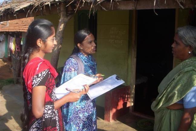 Image of two women conducting a survey at a medical camp.