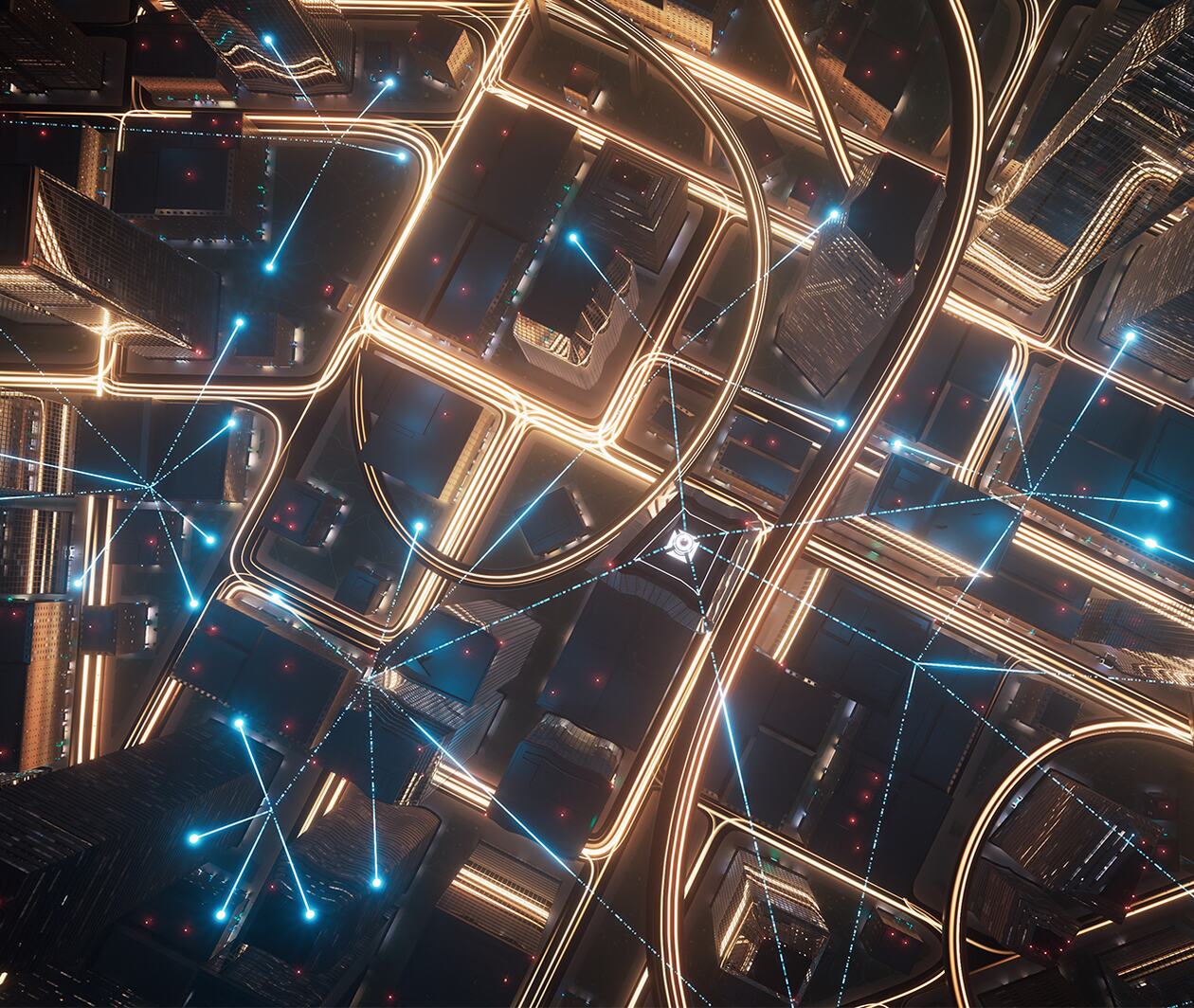 Arial view of a city in the dark with lights connecting the buildings