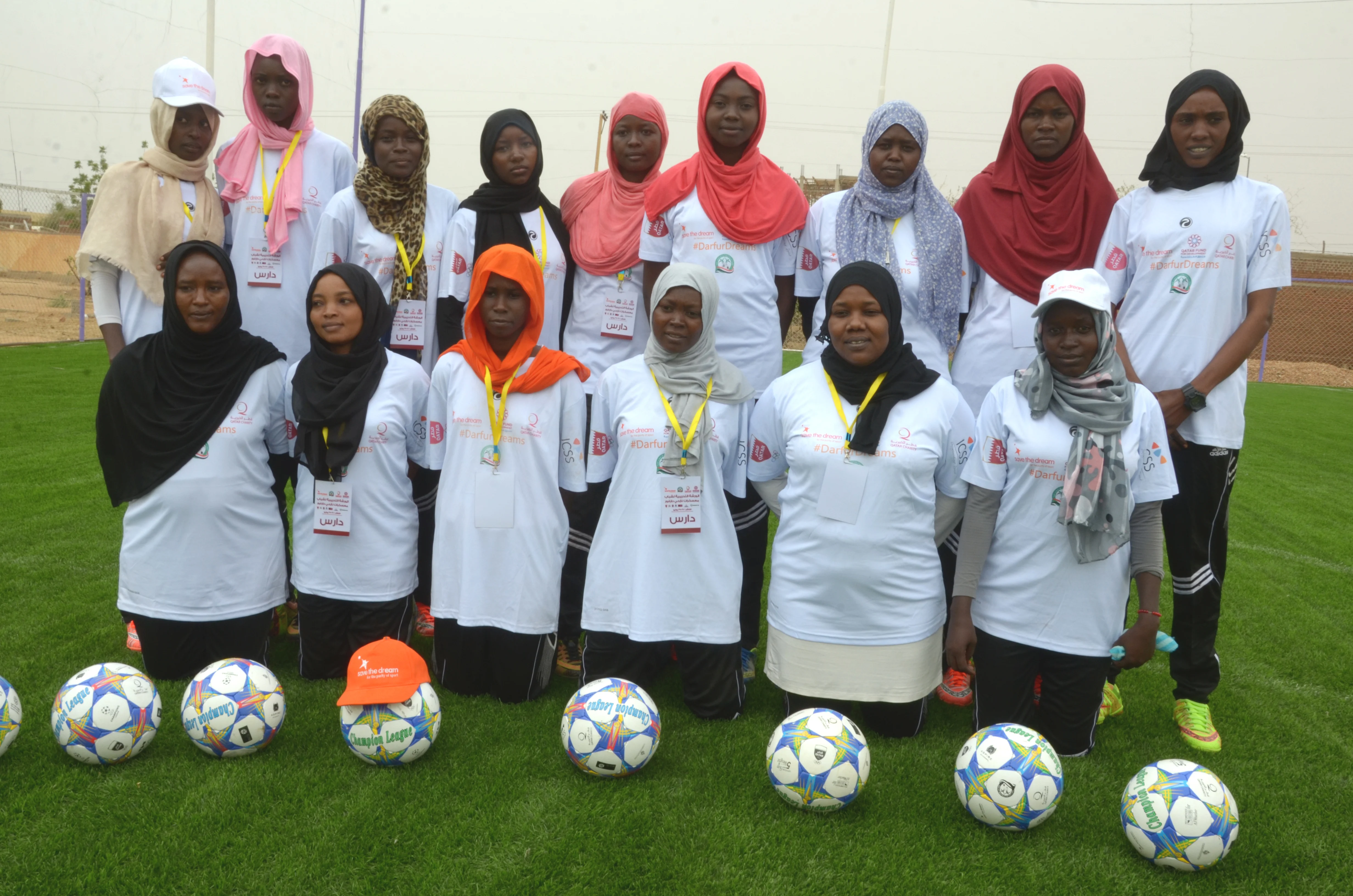 group of women wearing hijab with footballs in front of them training to be sport development coaches