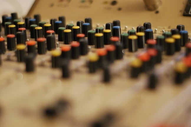 Colorful knobs on a sound mixing board.