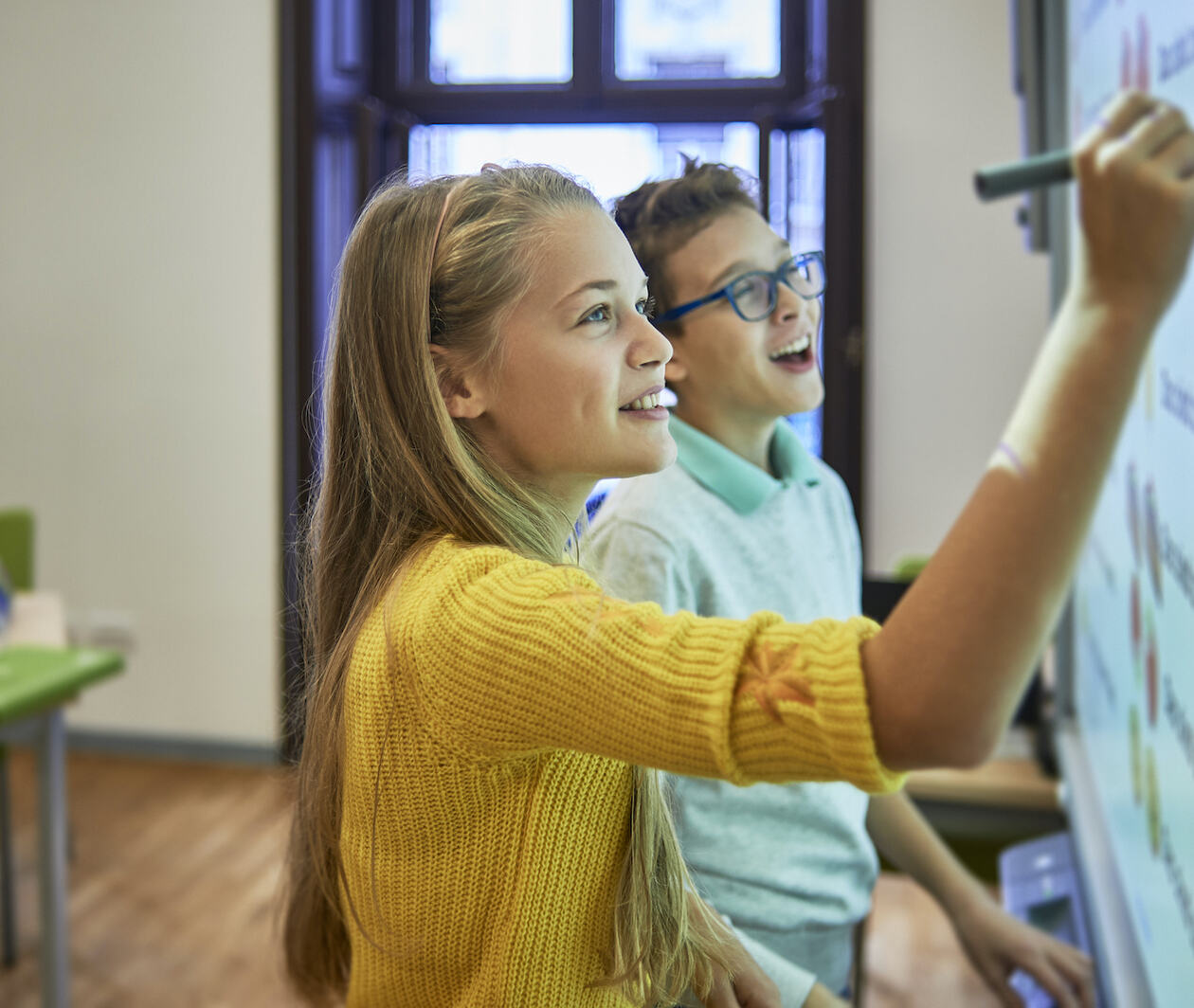 Image of girl writing on a whiteboard