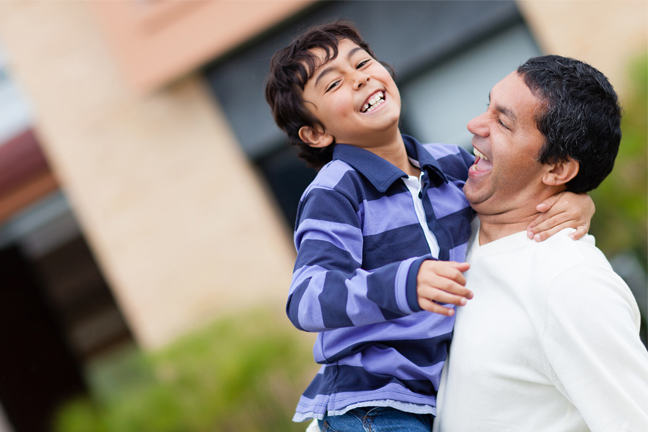 Man and boy laughing together