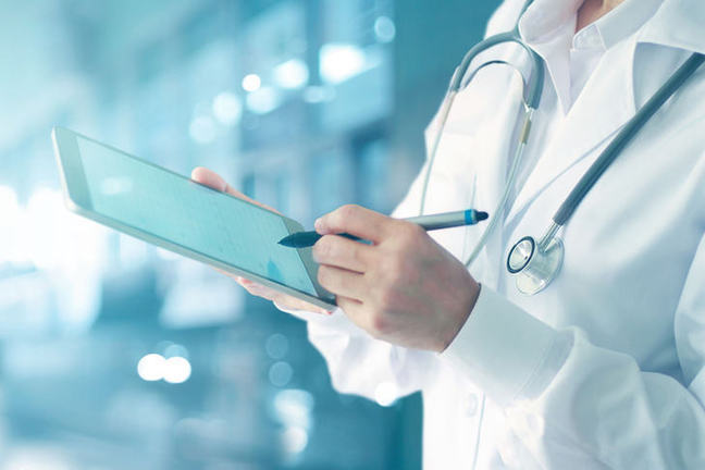 Healthcare professional using mobile device.
