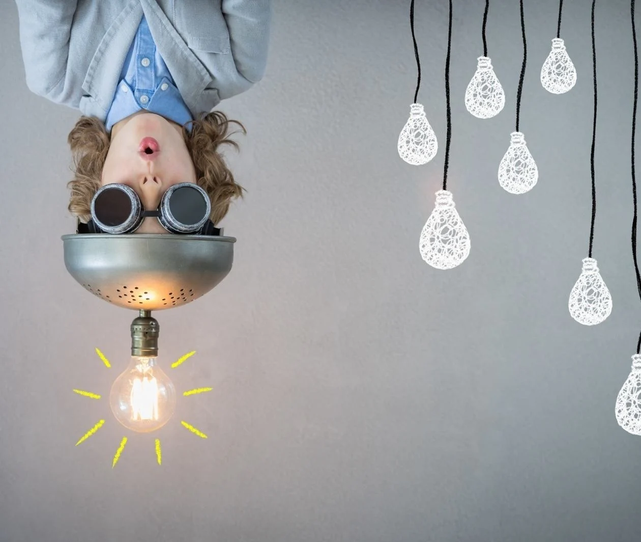 Person hanging face down with metal hat with a burning light and with dark goggles.