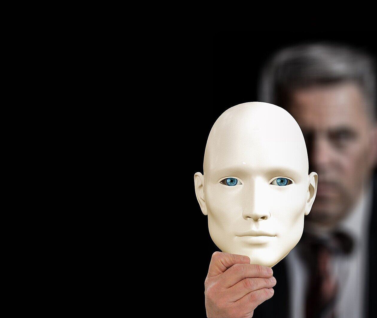 a mask held in front of a face