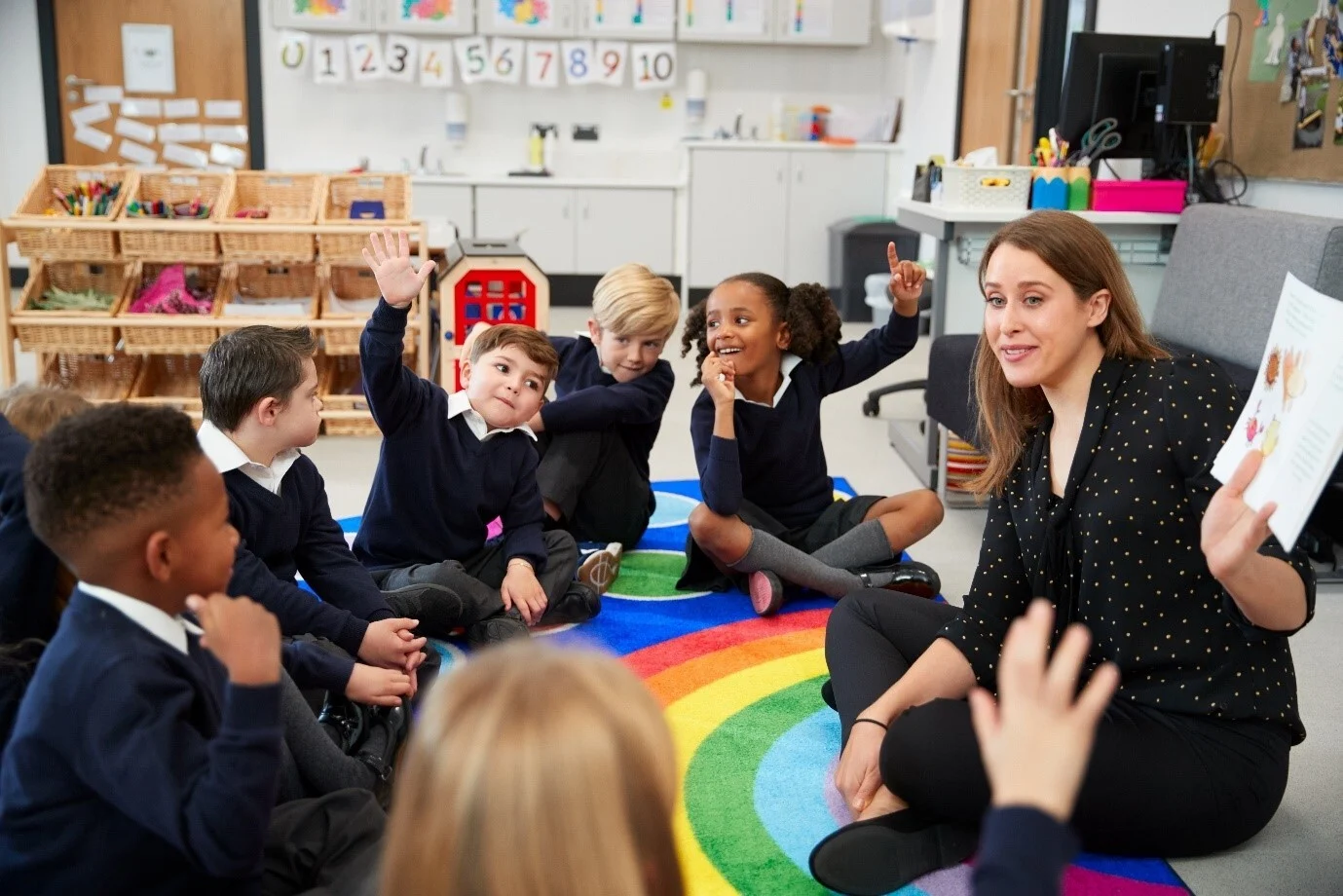 Teacher with primary children in a classroom