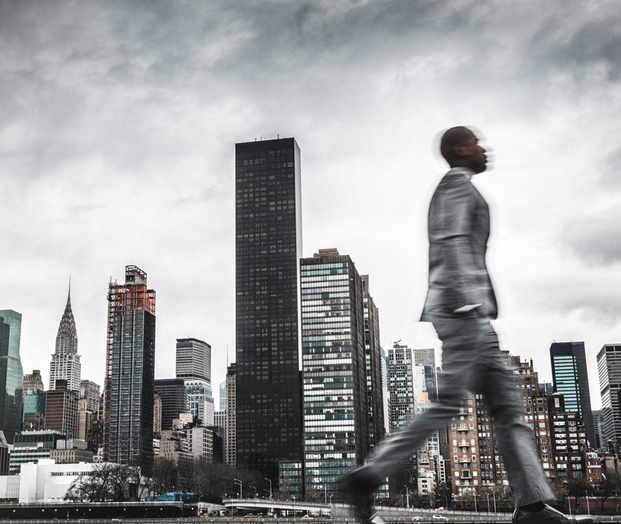 A businessman walking through a cityscape.