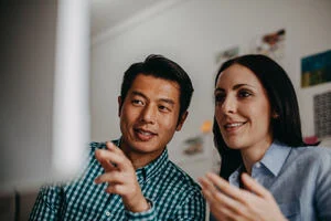 Man and a woman staring at a computer screen