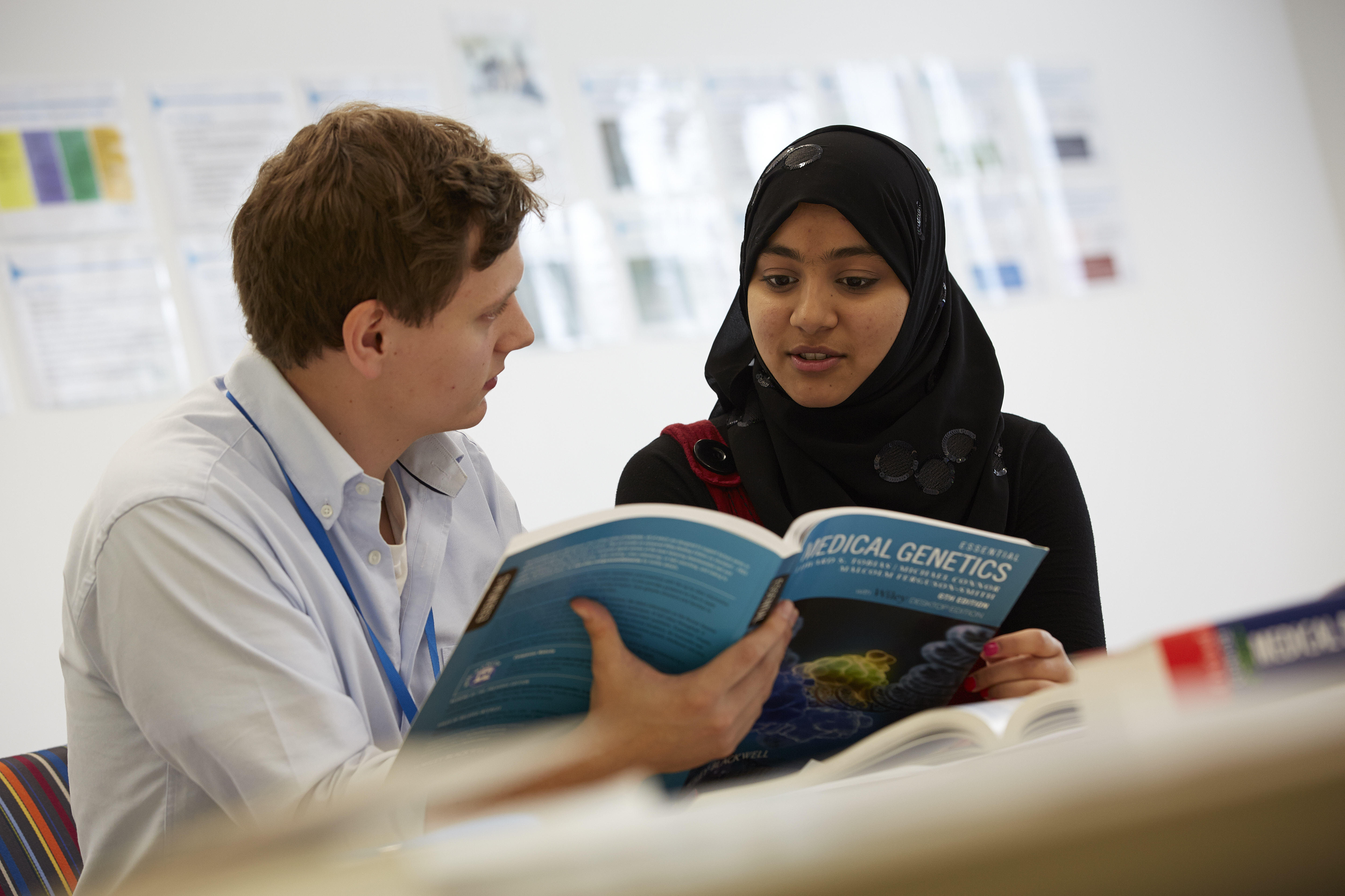 Doctor and student looking at a medical book