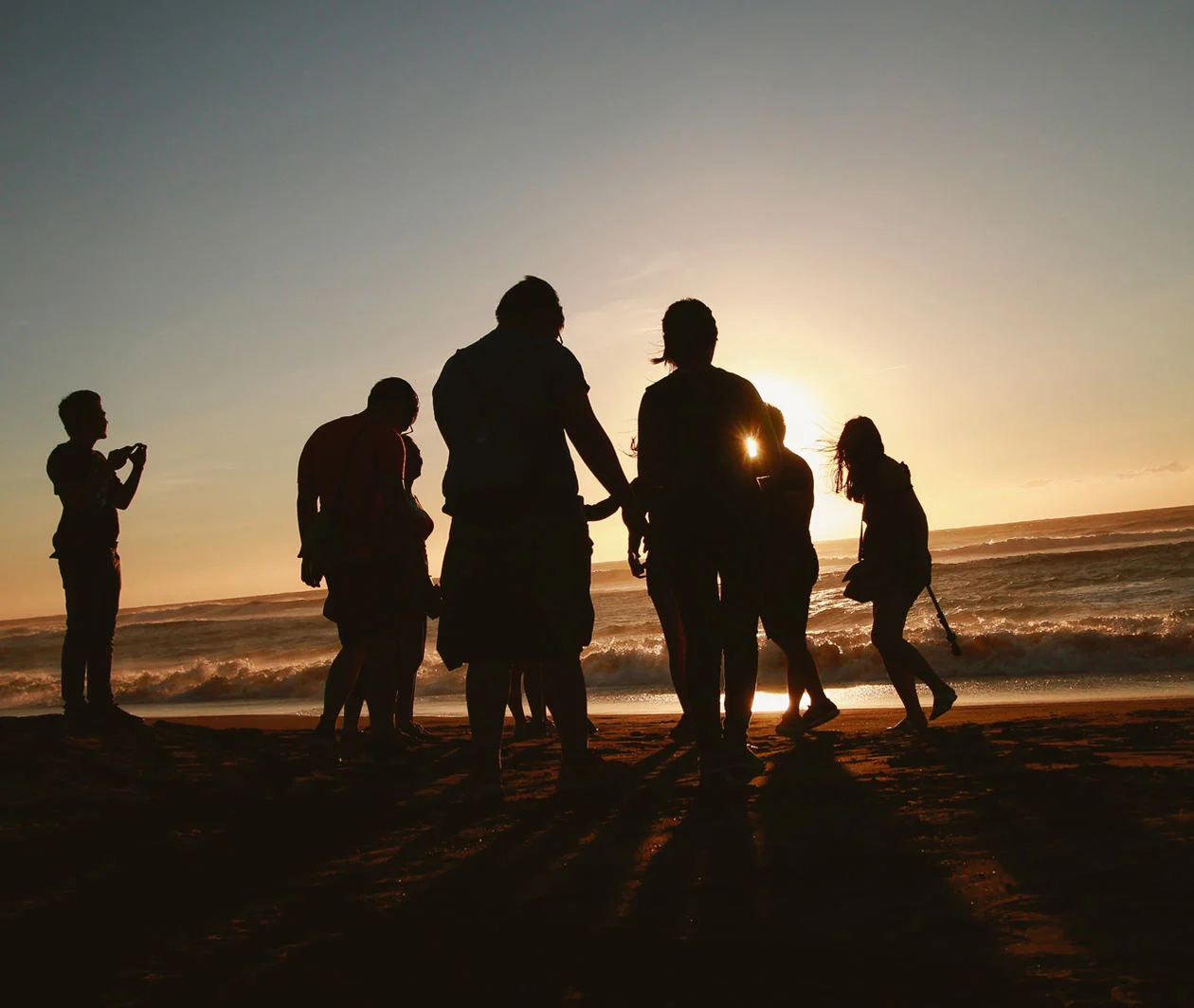 People on the beach at sunset