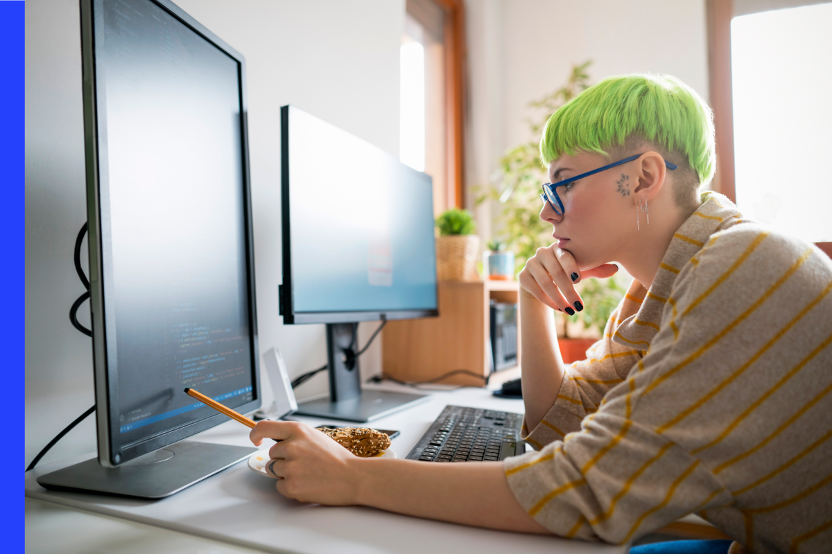 Woman looking at code on a monitor