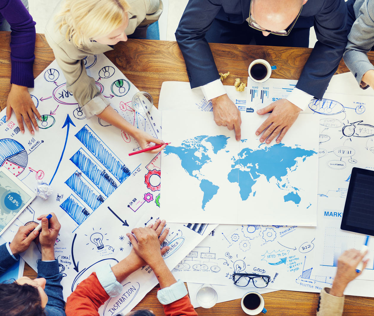 Image showing people meeting and planning using a world map