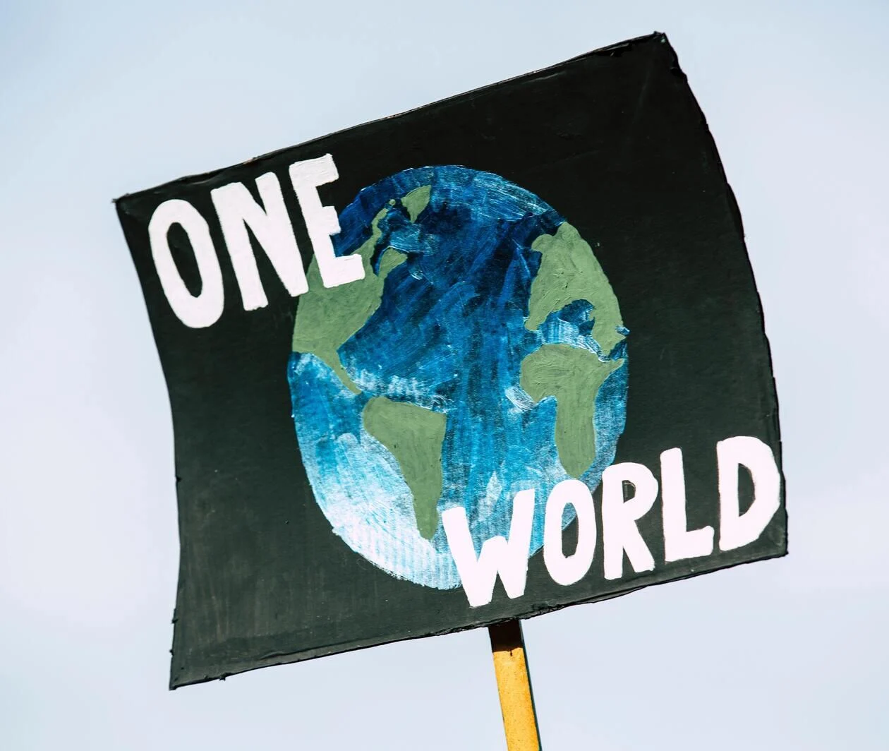 A sign that says 'one world'