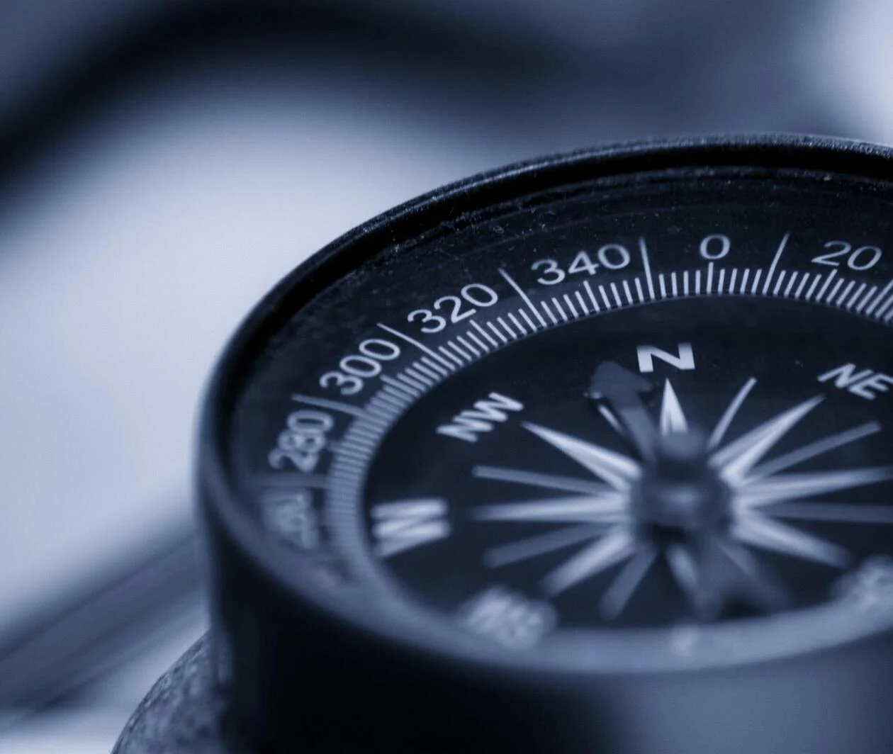 A closeup of a compass to represent how leadership can create and maintain a healthy organisational culture.