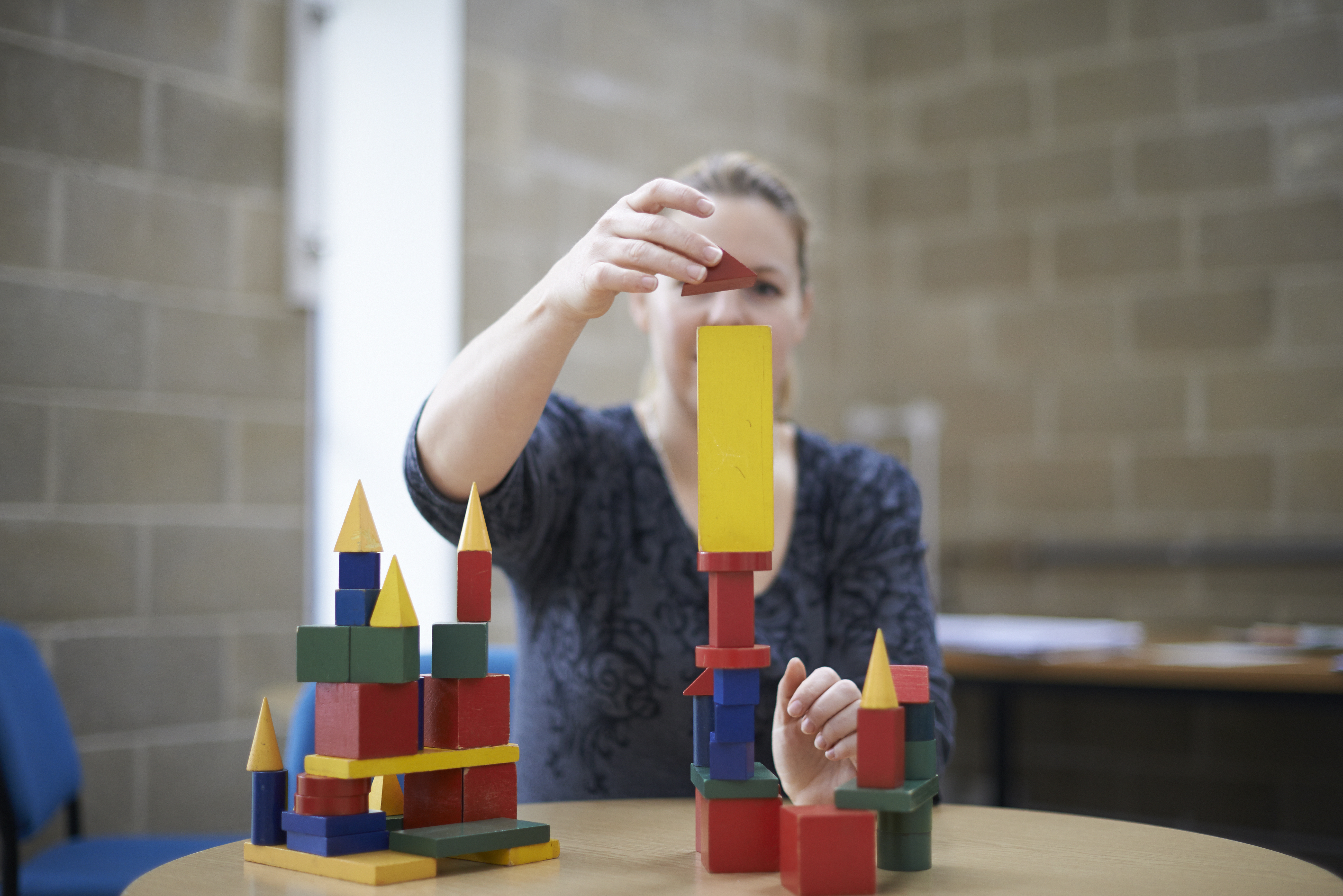 Parent using wooden blocks