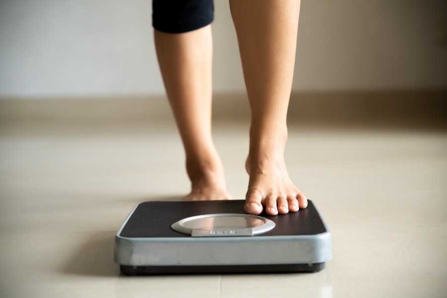Person stepping on weighing scales
