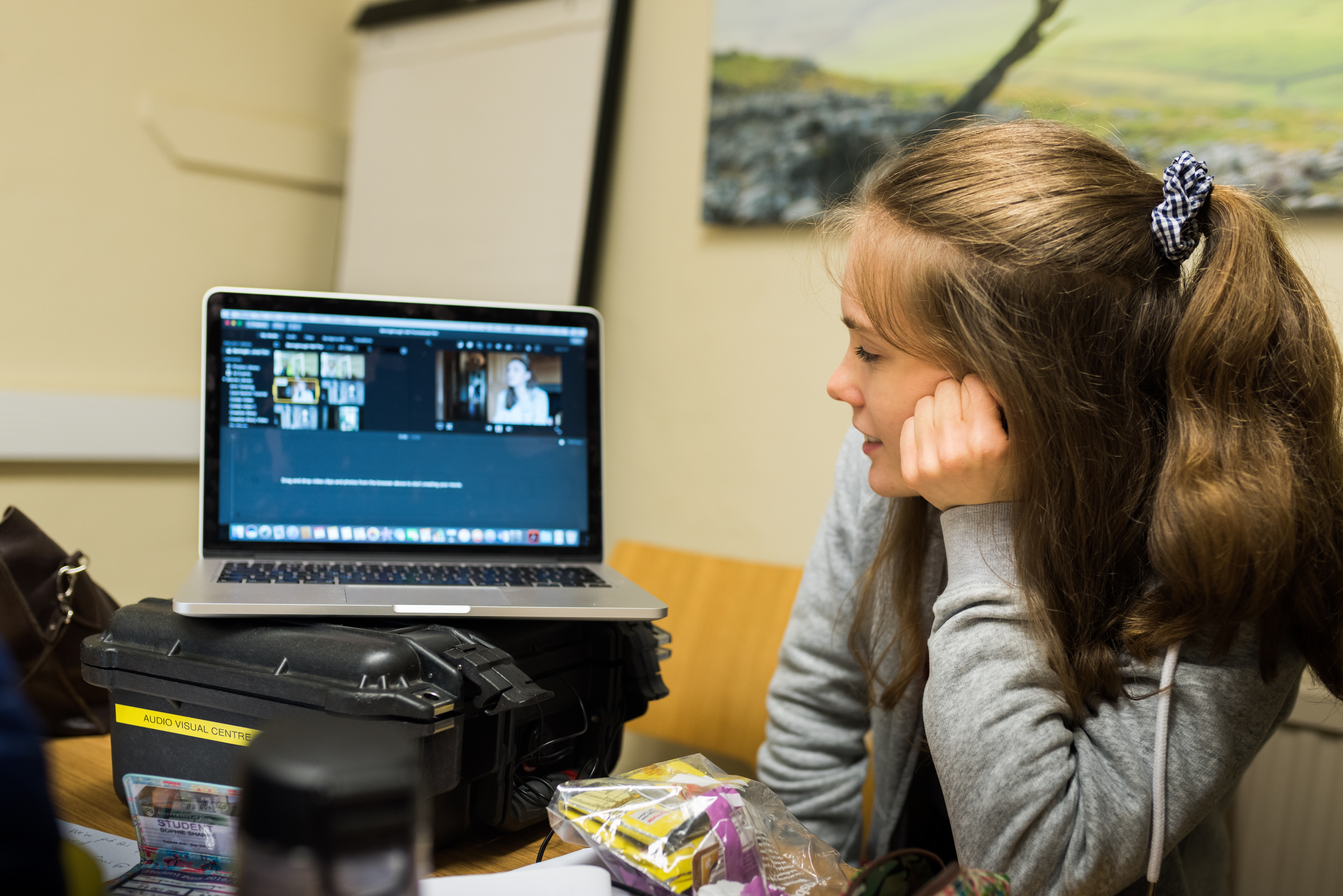 Student sat at a computer in an online meeting